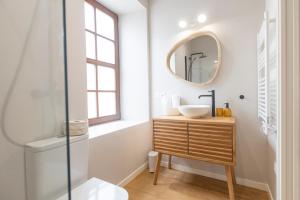 a bathroom with a sink and a mirror at Apartamentos Rurales Casa Carlota in Vegadeo +165 photos