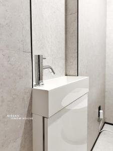 a bathroom with a white sink and a mirror at JY Snow in Kutchan +57 photos