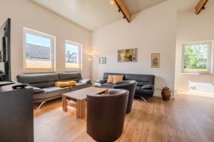 a living room with two couches and a table at Ferienwohnungen Mäusenest in Neroth