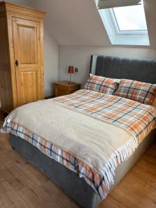 a bedroom with a large bed with a window at Craigtown view in Craigtown