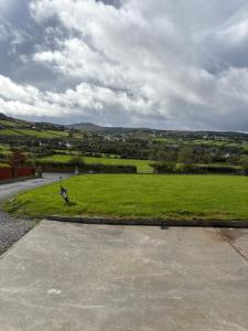 a person is walking in a field of grass at Craigtown view in Craigtown