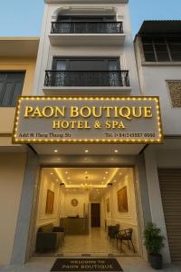 a hotel sign on the front of a building at Paon Boutique Hotel & Spa in Hanoi