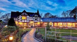 a large black and white house with lights at Beach View Apartment in West Kirby