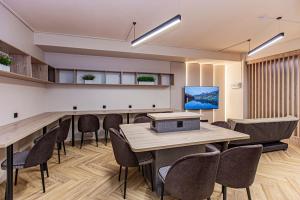 a conference room with a table and chairs at Luxx Aparts 2 in Almaty