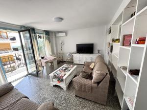 a living room with a couch and a tv at Paseo de la Carretera in Benidorm