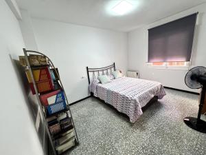 a bedroom with a bed and a book shelf at Paseo de la Carretera in Benidorm