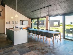 a dining room with a blue table and chairs at 12 person holiday home in Haderslev in Haderslev