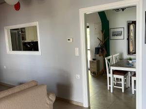 a living room with a table and a mirror at Nikotsaras beach house since 1930 in Acharavi +24 photos