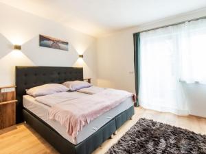 a bedroom with a bed and a large window at Chalet in Stuhlfelden near Ski Slopes in Stuhlfelden