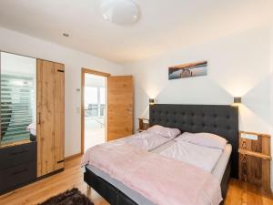 a bedroom with a large bed and a window at Chalet in Stuhlfelden near Ski Slopes in Stuhlfelden