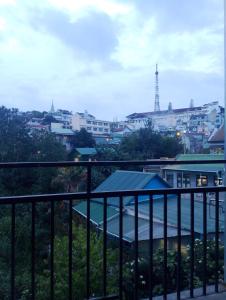 a view of a city from a balcony at nhà Anh TRƯỜNG Homestay in Da Lat