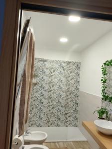 a bathroom with a toilet and a tub and a sink at La casa di mamma in Monopoli +59 photos