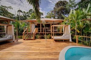 a resort with a pool and a house at Evia Life Resort in Puerto Viejo