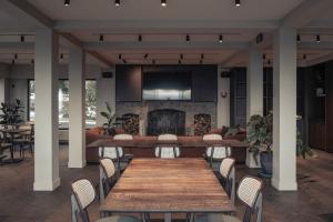 a dining room with a table and a fireplace at Hostellerie Kemmelberg in Kemmel