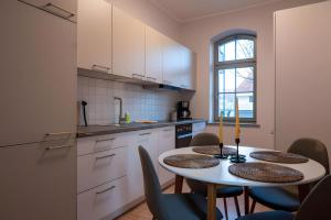 a kitchen with a table and chairs in a room at Ferienwohnung Lindner 2 in Weimar