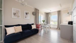 a living room with a couch and a table at Flatbook Seaside Baltica Tower - Apartment with Sea View, Gym & Parking in Gdańsk