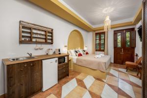 a kitchen and bedroom with a bed and a sink at The Old Symi in Symi