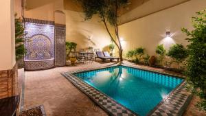 a swimming pool in the middle of a building at Riad Dar Pierre in Fès