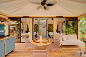 a living room with a couch and a table at Evia Life Resort in Puerto Viejo