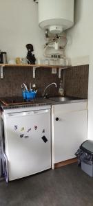 a kitchen with a sink and a stove at Studio calme in Saint-Nazaire +6 photos