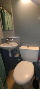 a bathroom with a white toilet and a sink at Studio calme in Saint-Nazaire