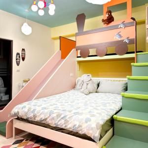 a childs bedroom with a bunk bed and stairs at Wawa Ocean Family B&B in Taitung City