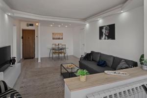 a living room with a couch and a table at Quiet Apartment Ruby Horizon in Bucharest