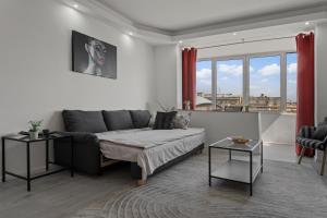 a living room with a couch and a table at Quiet Apartment Ruby Horizon in Bucharest