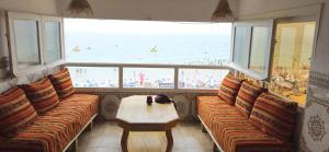 a restaurant with a table and a view of the beach at Idriss Seaview Guesthouse in Taghazout