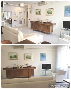 a living room with a white couch and a tv at Maison Clarabella in Vasto