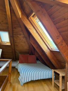 a room with a bed in a attic at Dúplex elegante de montaña con vistas y confort - Erta 6 in Pla de l'Ermita