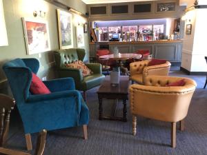 a bar with chairs and a table in a room at Royal Goat Hotel in Beddgelert