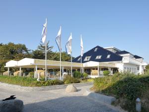 a group of flags in front of a building at Hotel Seeschlösschen in Hohwacht