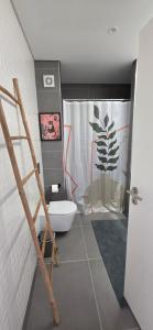 a bathroom with a toilet and a shower curtain at Algarve Dream Escape in Armação de Pêra +29 photos