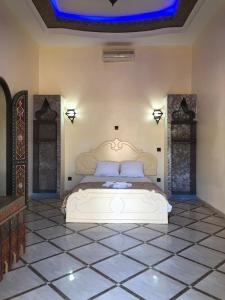 a bedroom with a white bed with a blue ceiling at Eden Suites 