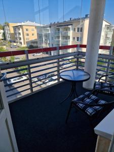 a balcony with a table and chairs on a building at Top-Floor Hideout with Sauna near City Center in Rovaniemi