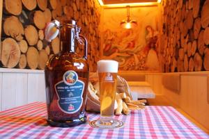 a bottle of beer sitting on top of a table at The LP apartment in Feltre +4 photos