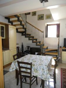 a dining room with a table and a staircase at Casa Filomena in Tramonti