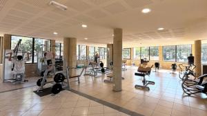a gym with people exercising on machines in a room at Mobil home - 8 couchages avec lit bébé - ECRIN DE SÉRÉNITÉ - Camping TIKAYAN 5 étoiles - Le Muy in Le Muy