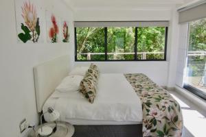 a bedroom with a bed and a large window at Pecan Tree Forest Studio A with Terrace in Stellenbosch