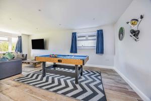 a living room with a ping pong table in it at Windrocks - Bracklesham Bay in Chichester