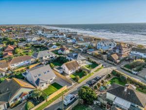 an aerial view of a residential neighborhood next to the ocean at Windrocks - Bracklesham Bay in Chichester +50 photos
