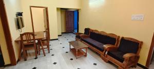 a living room with a couch and a table at SP resort inn in Yercaud