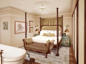 a bedroom with a bed and a bath tub and a tub at The Ned in London