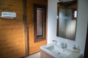 a bathroom with a white sink and a mirror at Acogedora Casa de Madera con piscina in Güimar +37 photos