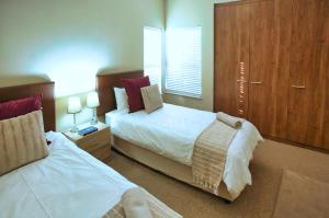 - une chambre avec deux lits, une armoire et une fenêtre dans l'établissement Break-A-Way, Langebaan, 4-sleeper, à Langebaanweg