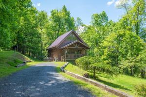 a log cabin in the middle of a road at Updated Cabin Mins from Downtown West Jefferson- Hot Tub, Porches, Dogs OK in West Jefferson