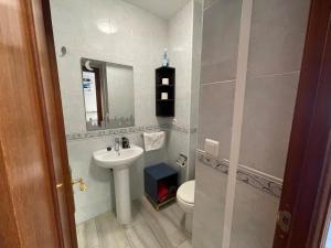 a bathroom with a sink and a toilet and a mirror at Estudio Benalmádena Costa in Benalmadena Costa +24 photos