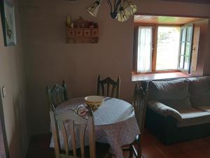 a table and chairs with a table and a table and a table and a table at Casa De la Agüera in Busto