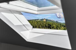 a window with a view of a mountain at Apartmány s výhledem na Plešivec by Mountain ways in Abertamy